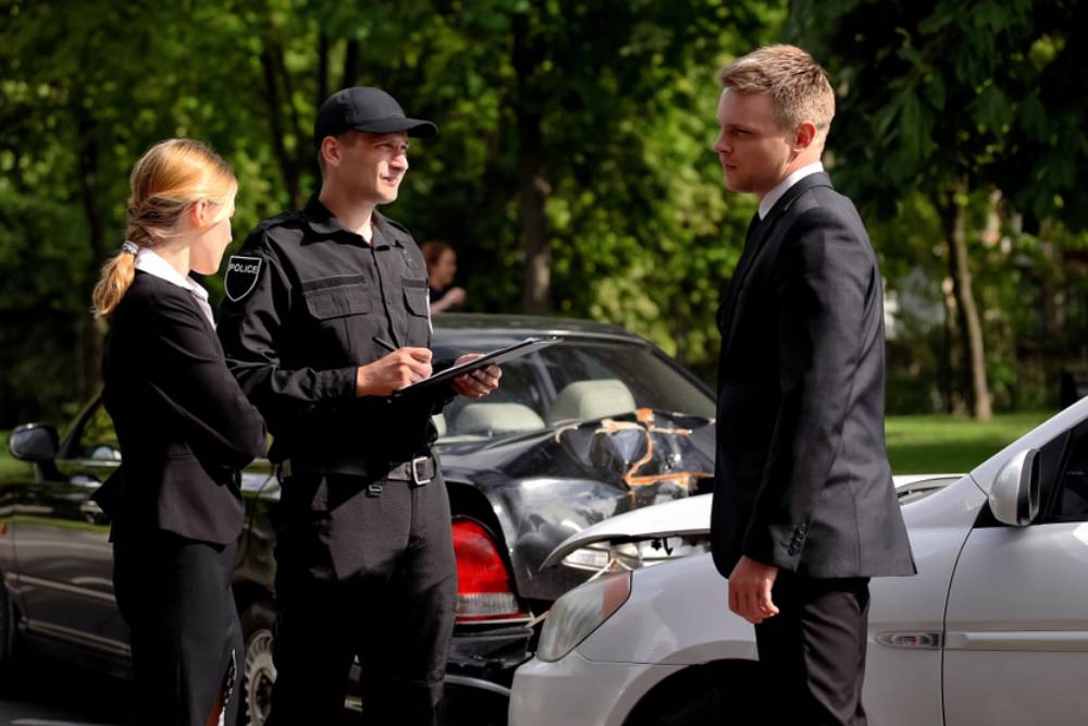 Car drivers and policeman near wrecked autos road, traffic collision, insurance
